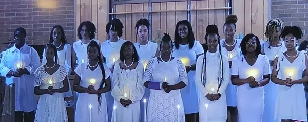 2024 Helen Sheffield Membership Induction — members holding candles